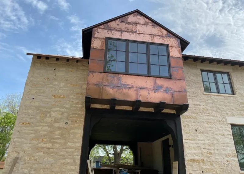 Copper metal panel facade on a stone building for Roof Repair in Seminole