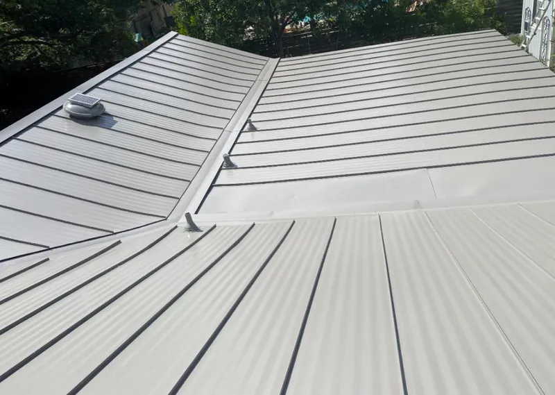 Solar attic fan installed on a metal roof for Roof Ventilation in Seminole